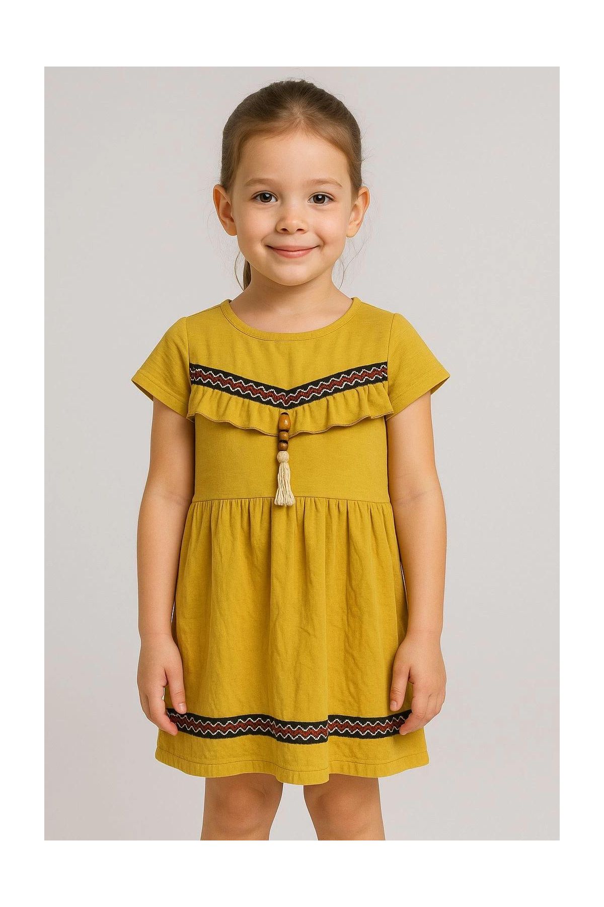 Önü püsküllü boncuk detaylı kız çocuk elbisesi hardal